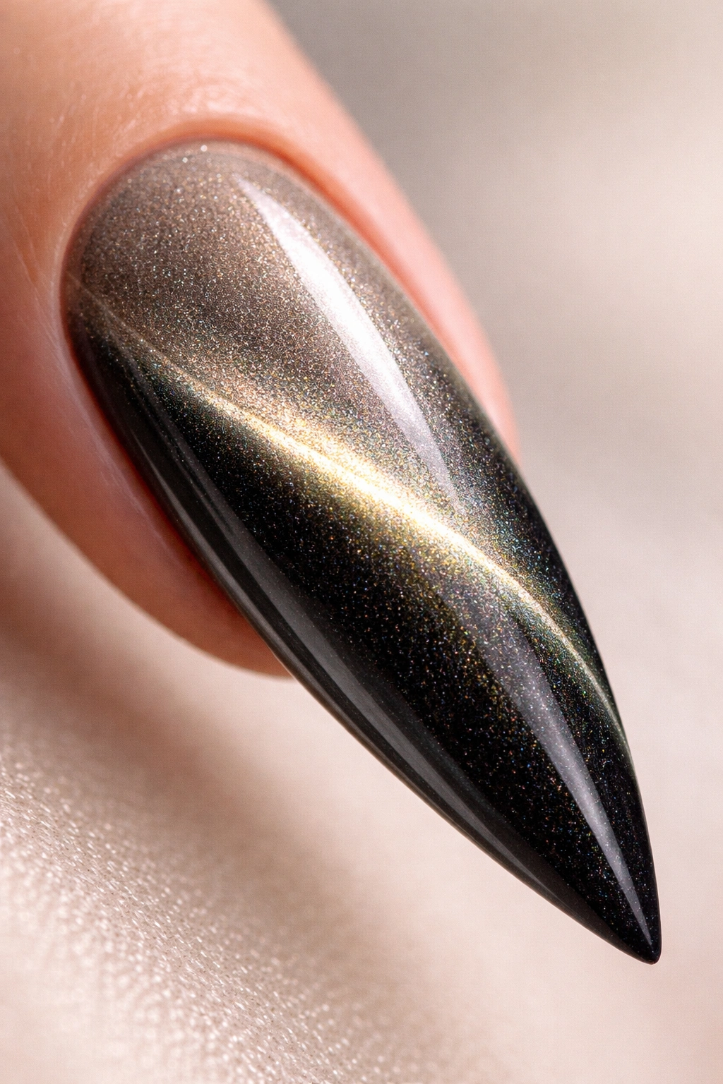 Close-up of a stiletto nail with gradient and magnetic cat-eye lines