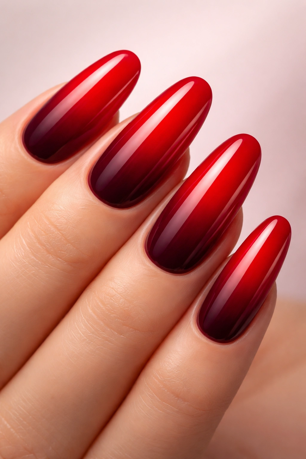 Close-up of ombré nails transitioning from cherry red to burgundy