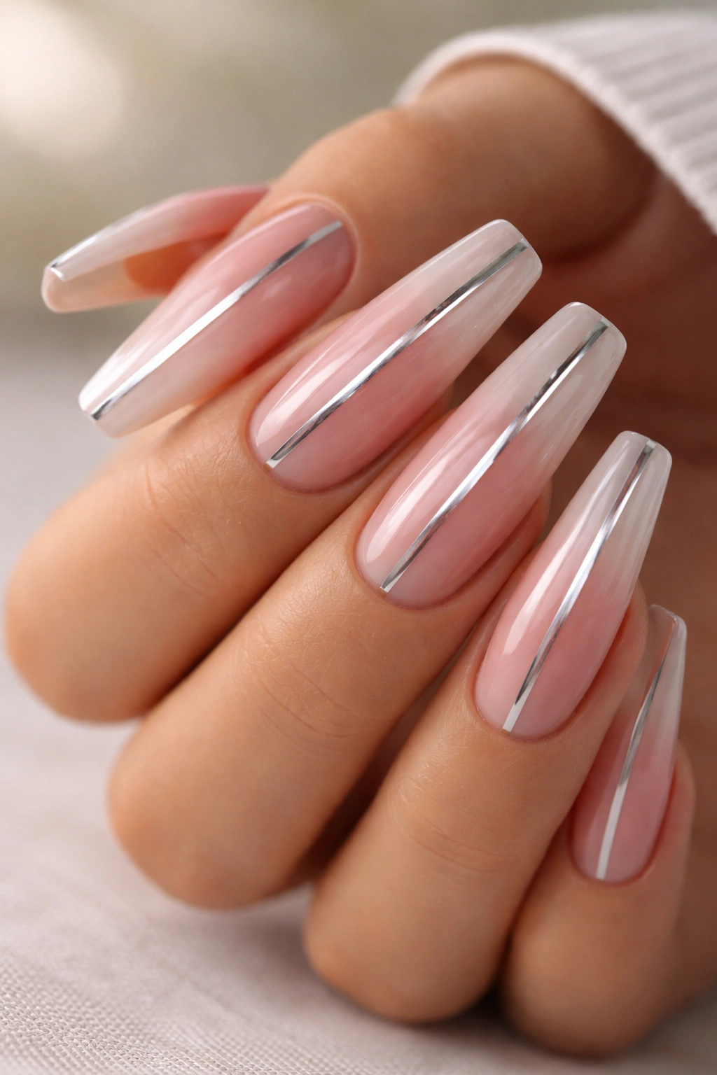 Nude-to-rose ombré coffin nails with a chrome stripe along the center