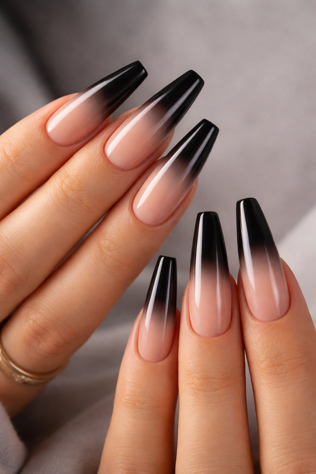 Close-up of coffin nails with nude to black ombré gradient