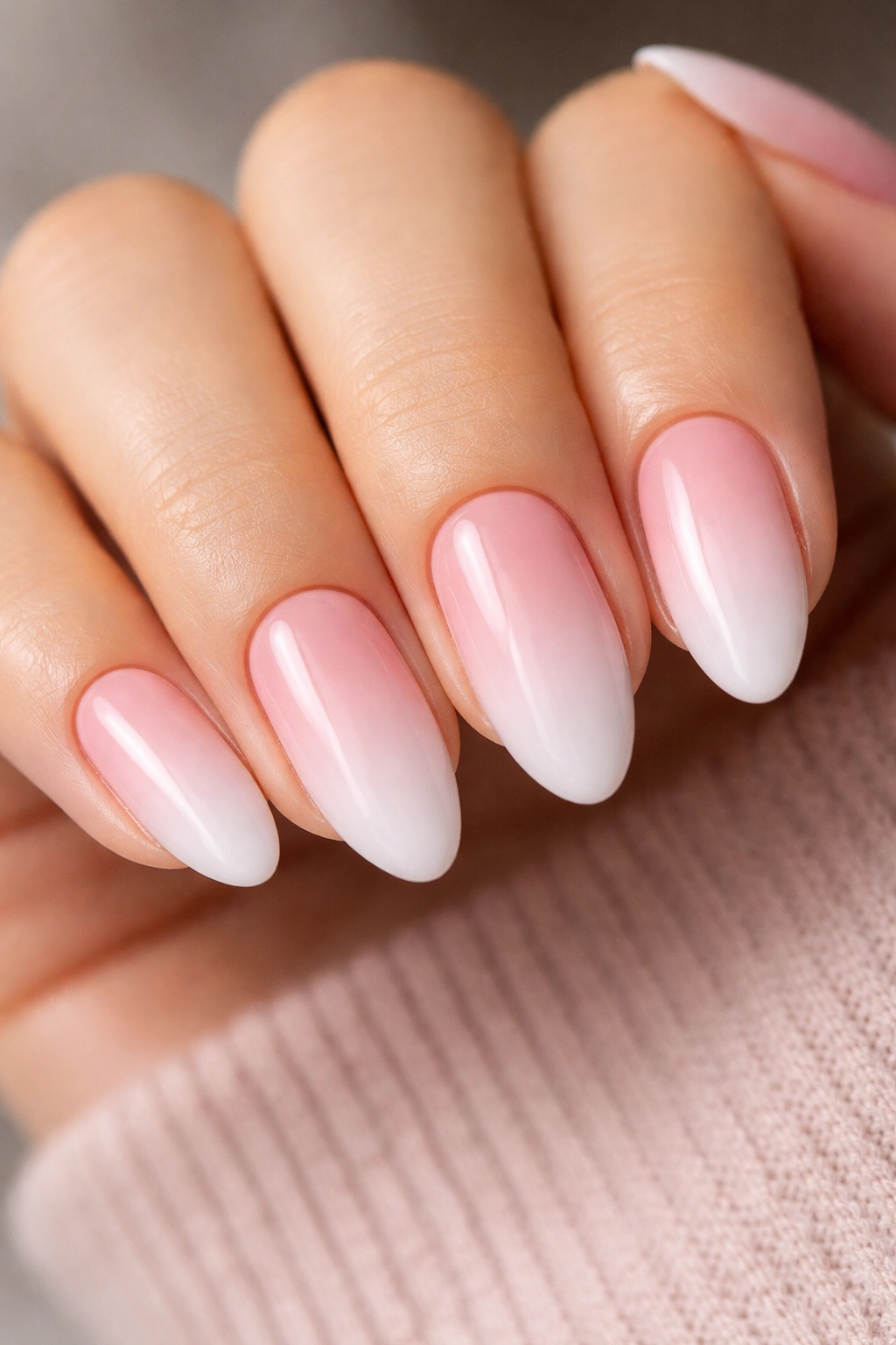 Nails with pink-to-white ombré gradient across each nail