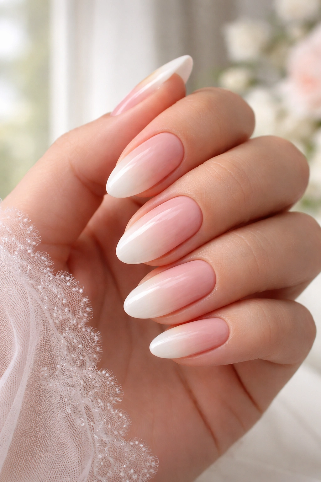 Nails with a soft blush to ivory ombré French gradient.