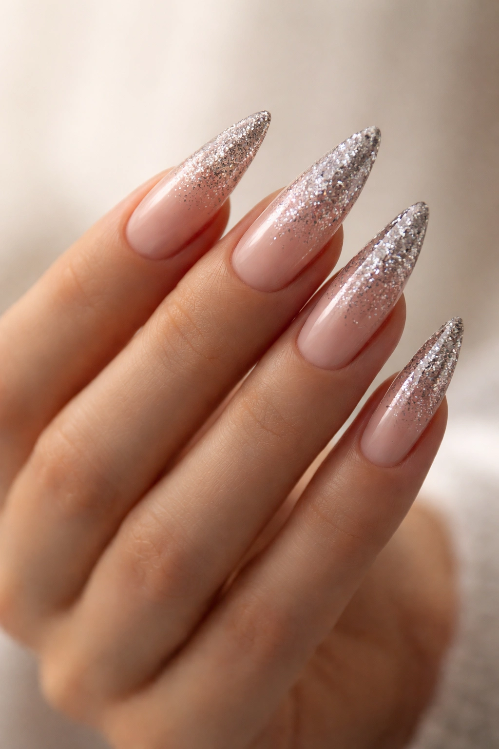 Close-up of hand displaying ombré glitter across all nails with a gradient sparkle
