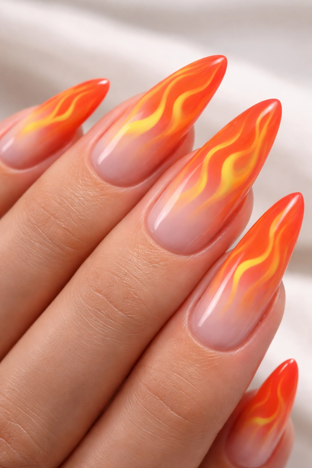 Close-up of ombré gradient flame nails with orange flame silhouettes