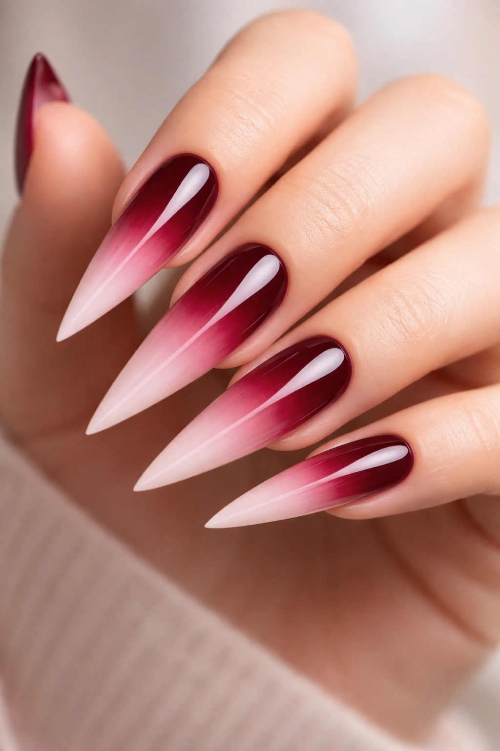 Ombre gradient stiletto nails transitioning from dark to light