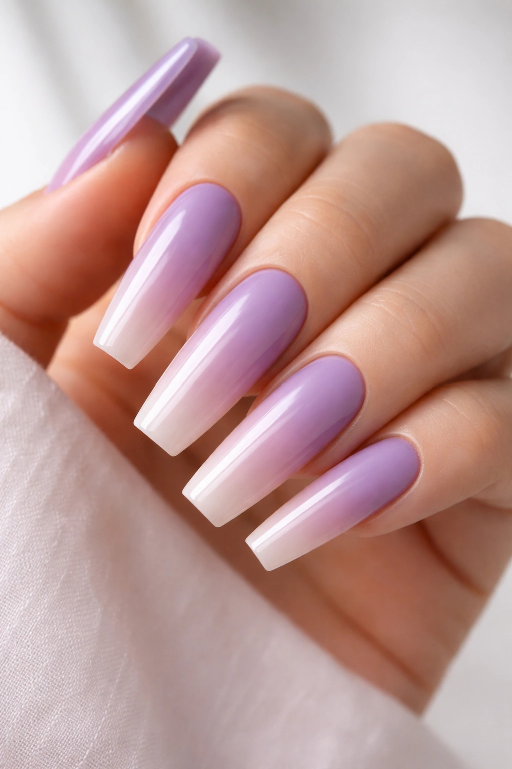 Close-up of ombré lavender to nude coffin nails with seamless gradient