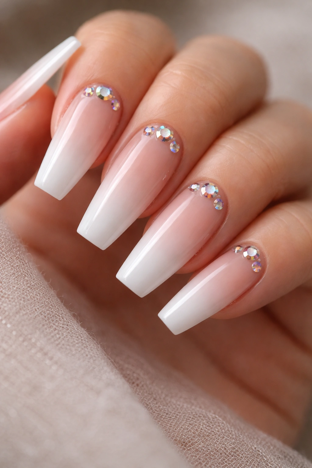 Ombré nude-to-white nails with AB crystal scatter