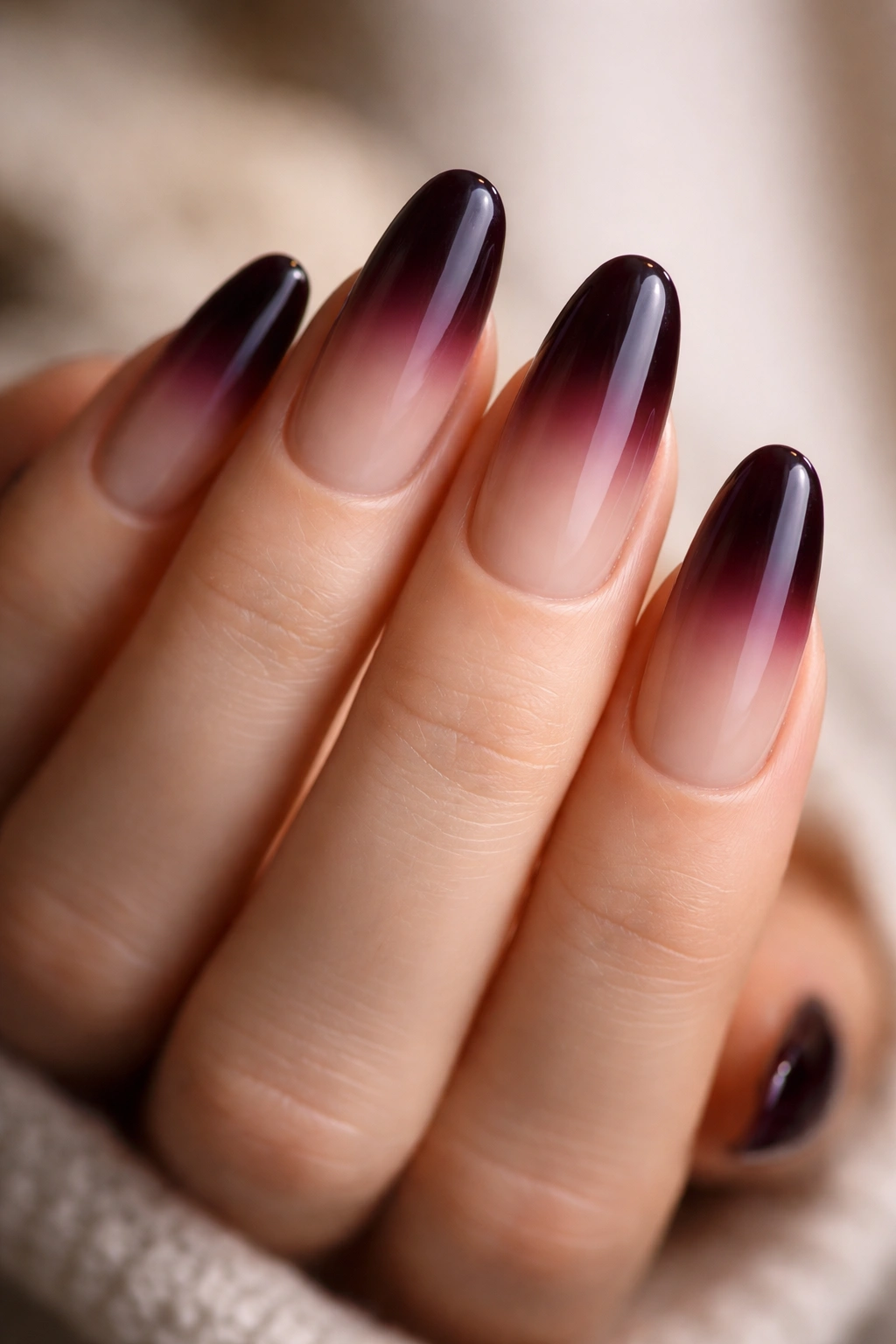 Long oval nails with black cherry at tip fading to bare nude