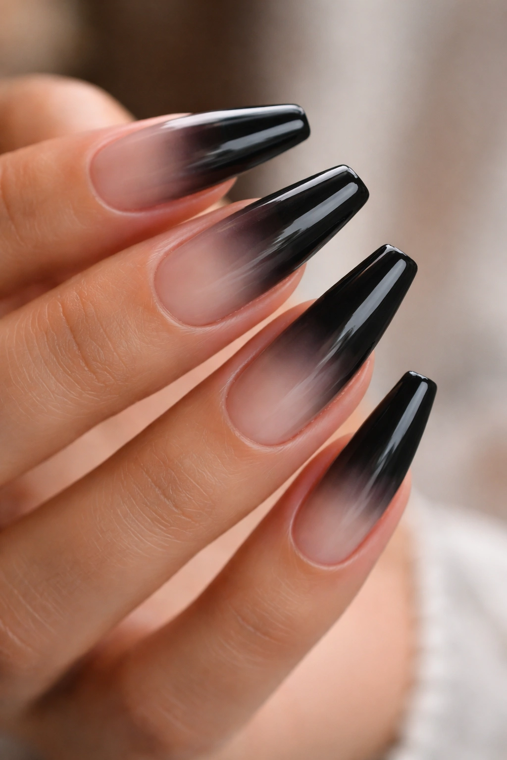 Black ombré nails fading into sheer nude on ballerina shape
