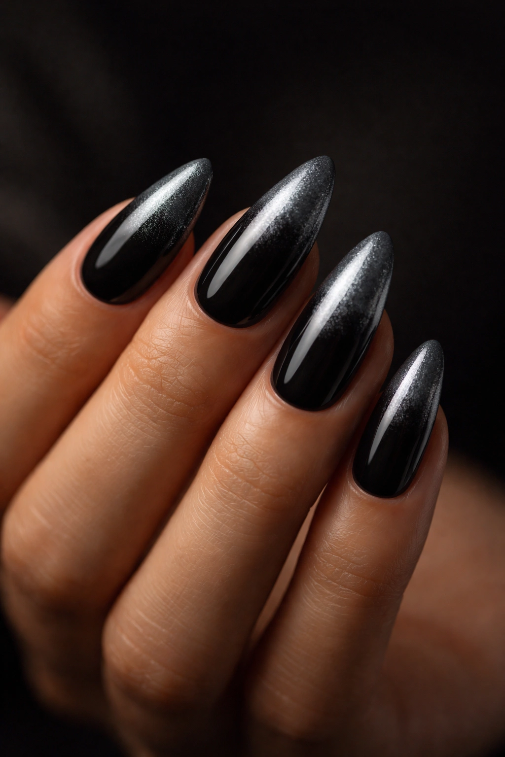 Almond nails black to gunmetal grey ombre with metallic finish.