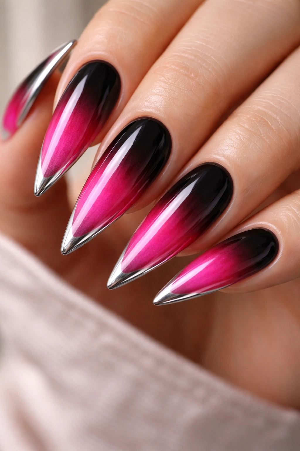 Stiletto nails with black to pink ombré and metallic tip line