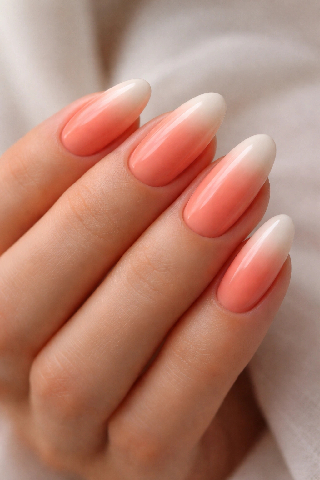 Almond nails coral to ivory ombre.