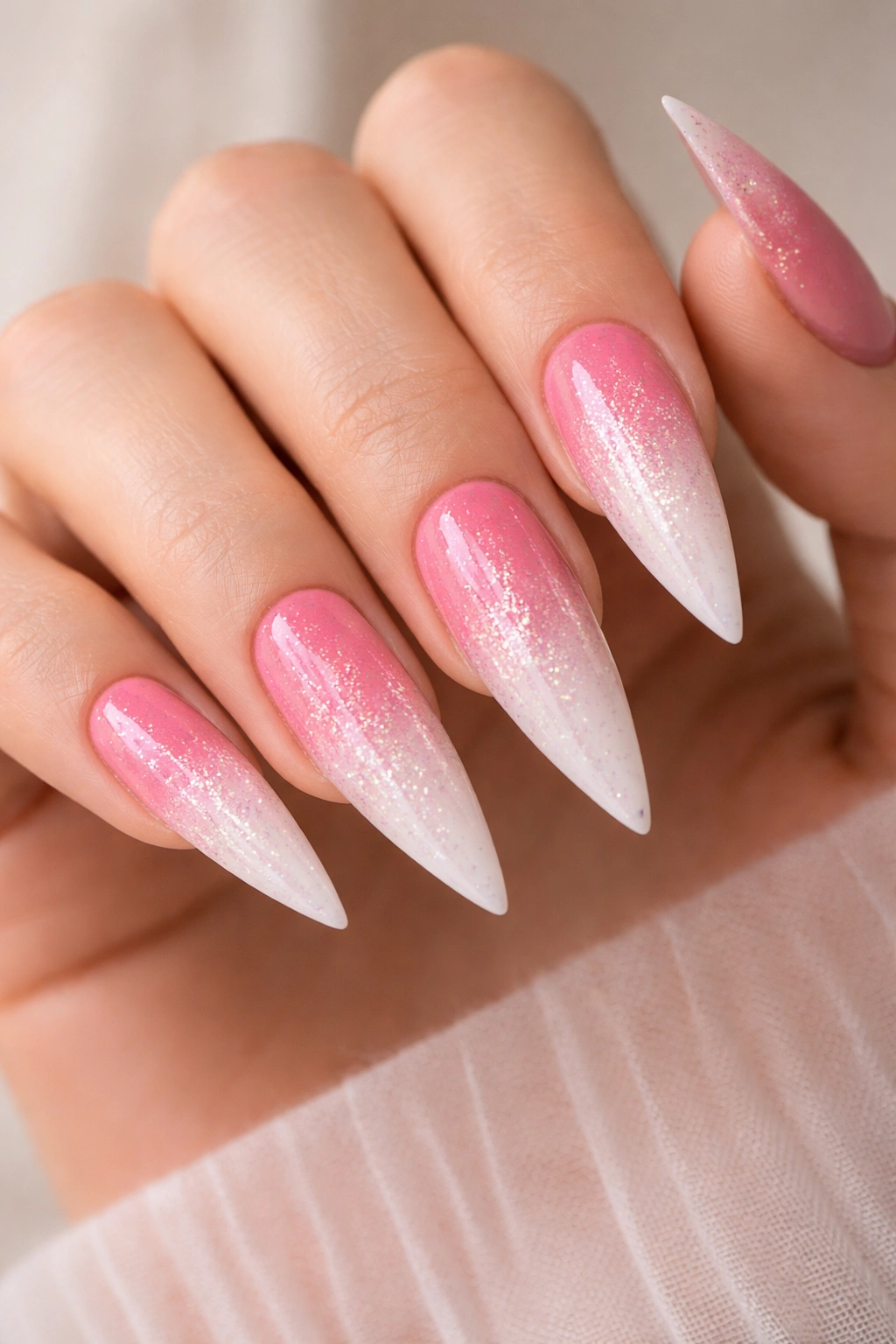 Ombre pink to white stiletto nails with glitter fade