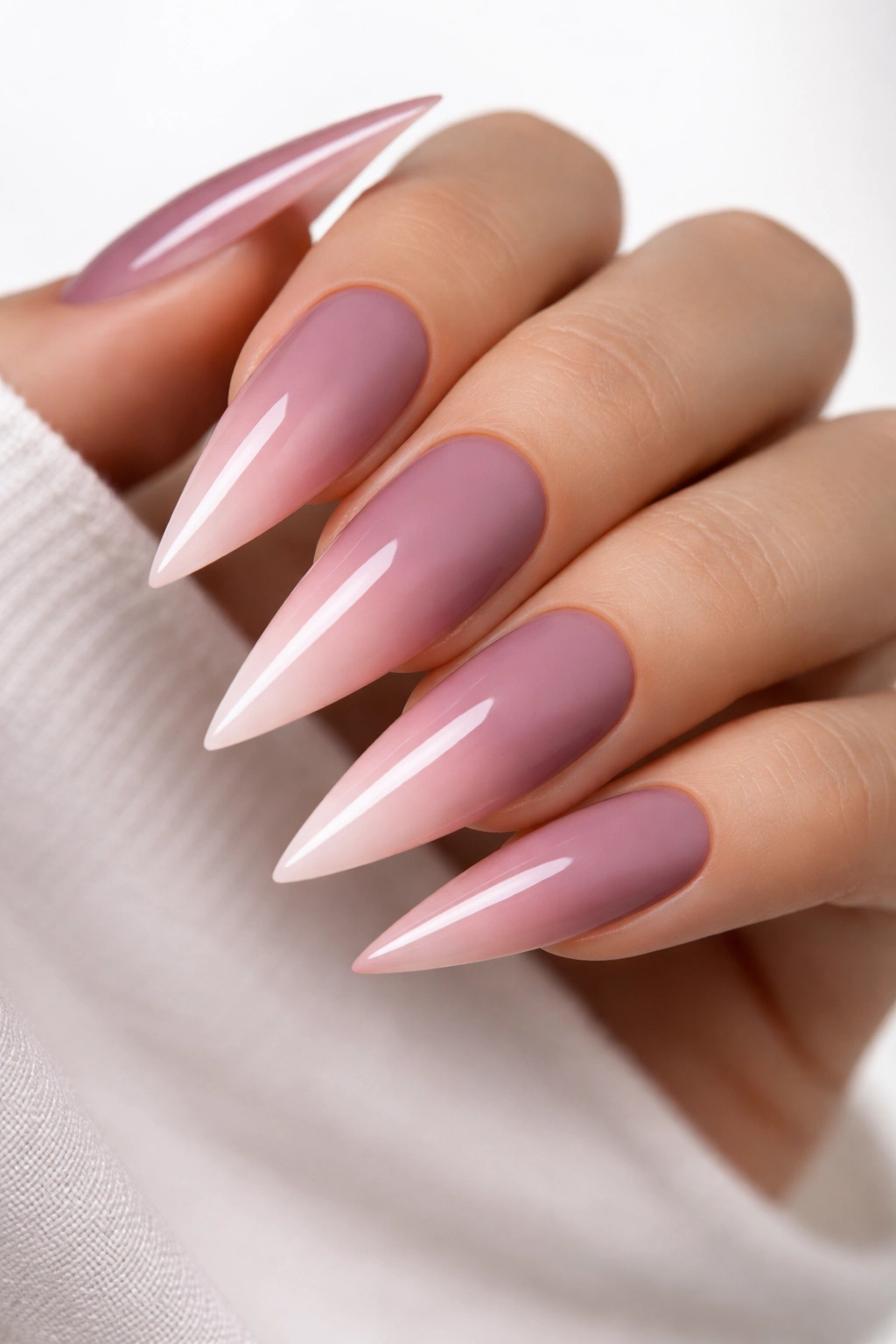 Close-up of deep mauve-to-pink ombré stiletto nails with matte and glossy finishes
