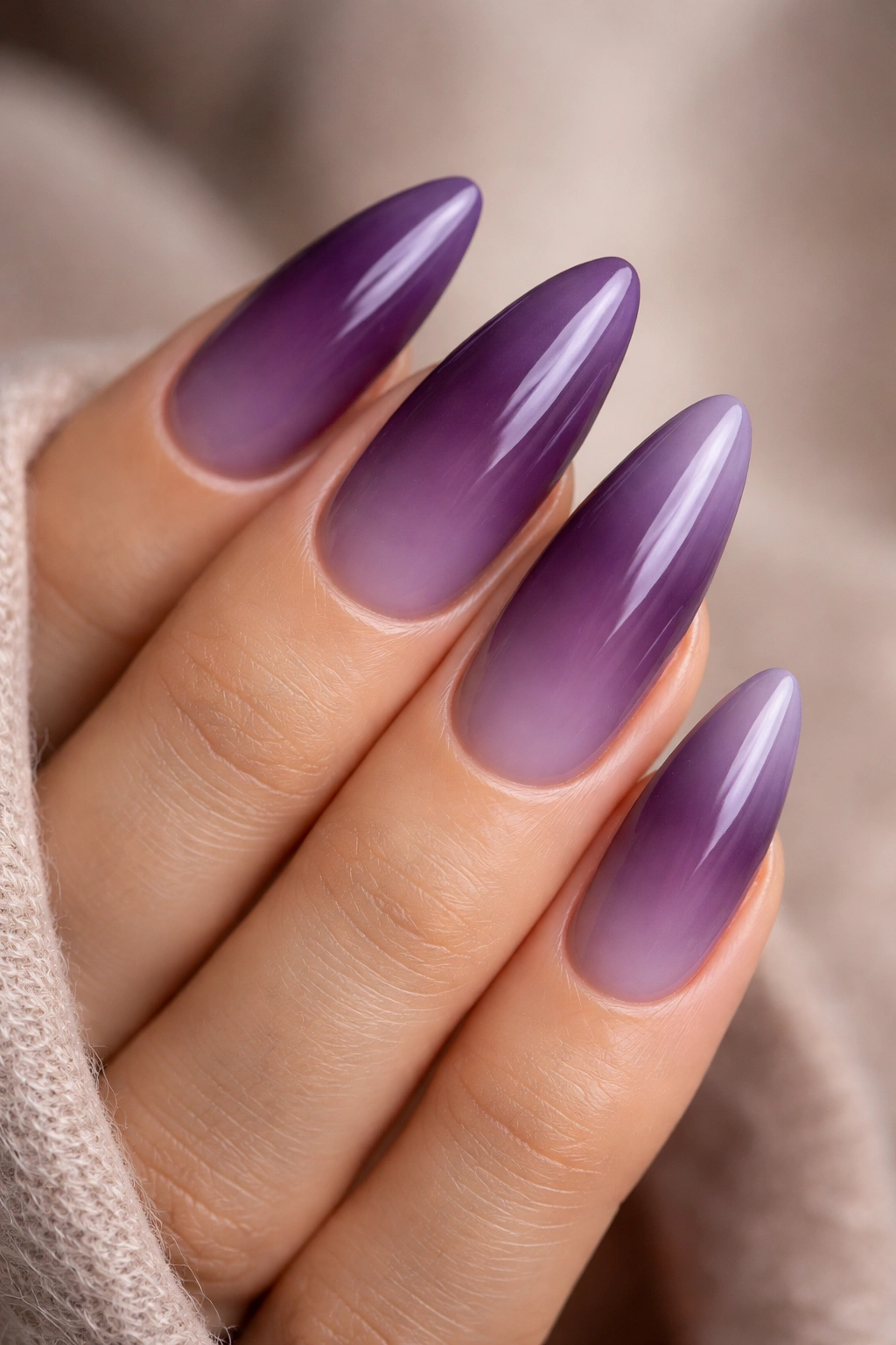 Almond nails with deep plum to gray-lilac ombre.