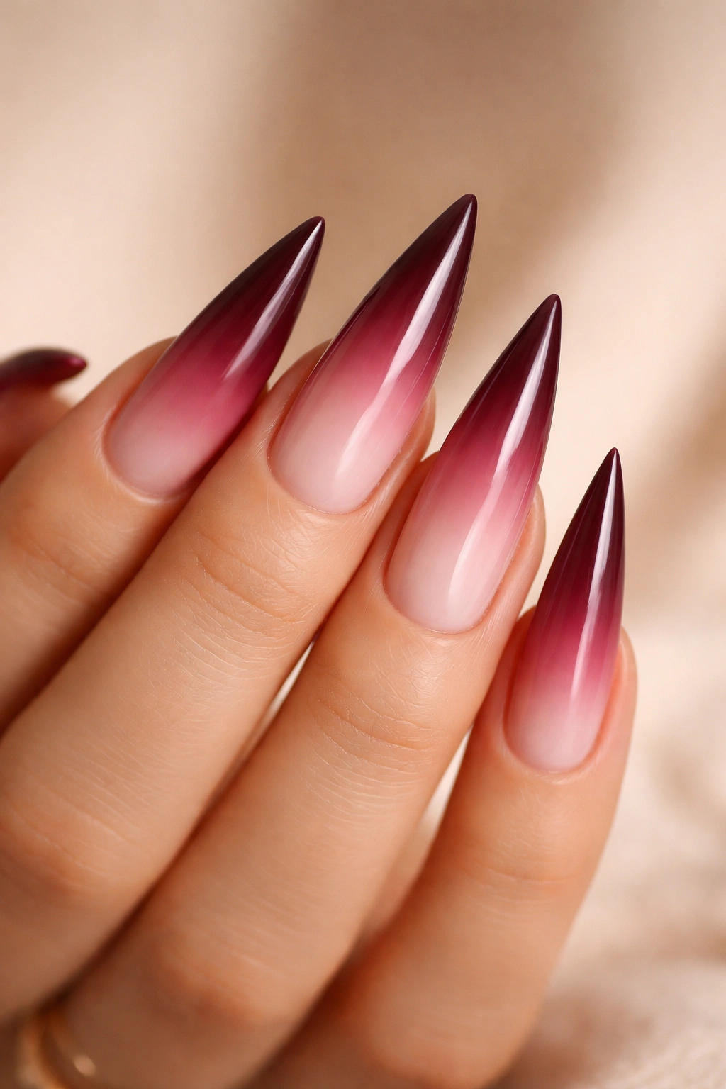 Stiletto nails with burgundy to pink ombre gradient