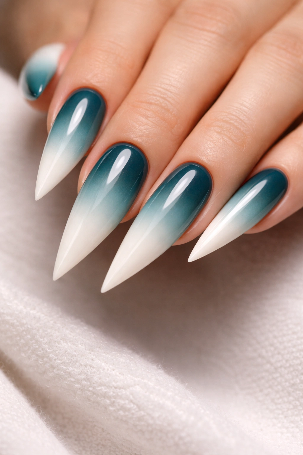 Stiletto nails with teal to white ombre gradient