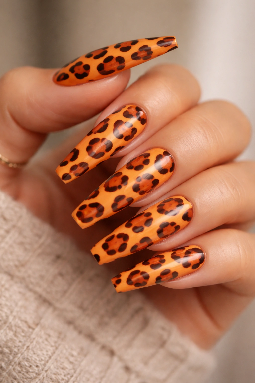 Coffin nails with orange leopard print rosettes.