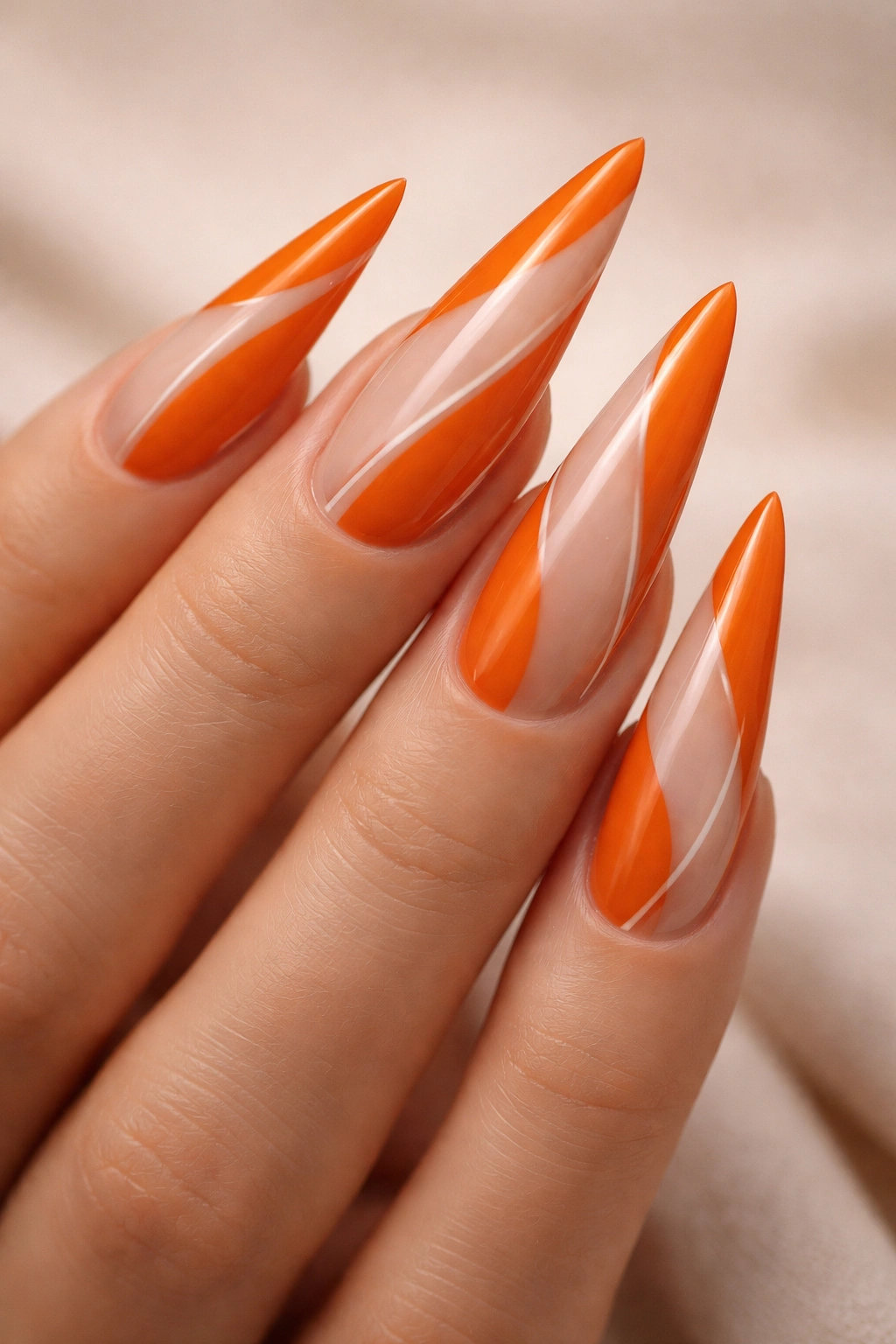 Close-up of orange nails with negative space abstract design