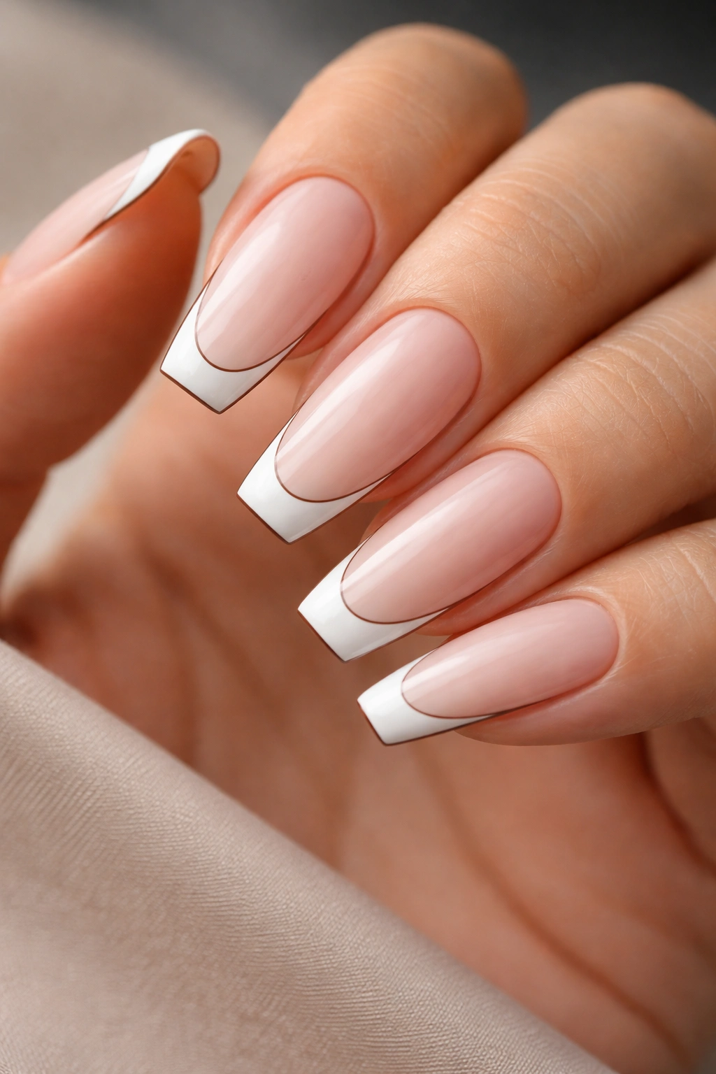 Ballerina nails with white tips outlined by a whisper-thin brown border