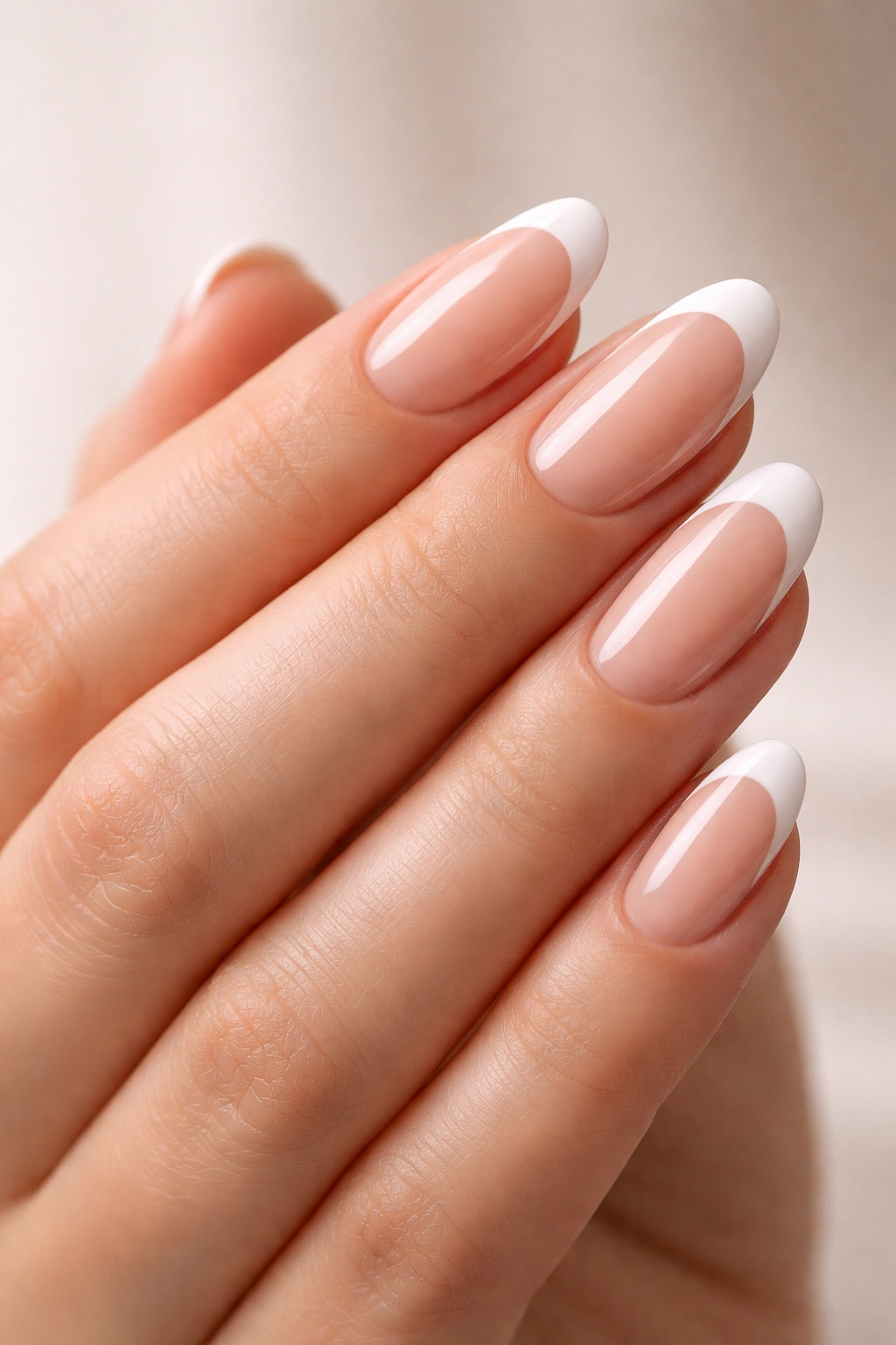 Close-up of oval nails with French tips on nude base