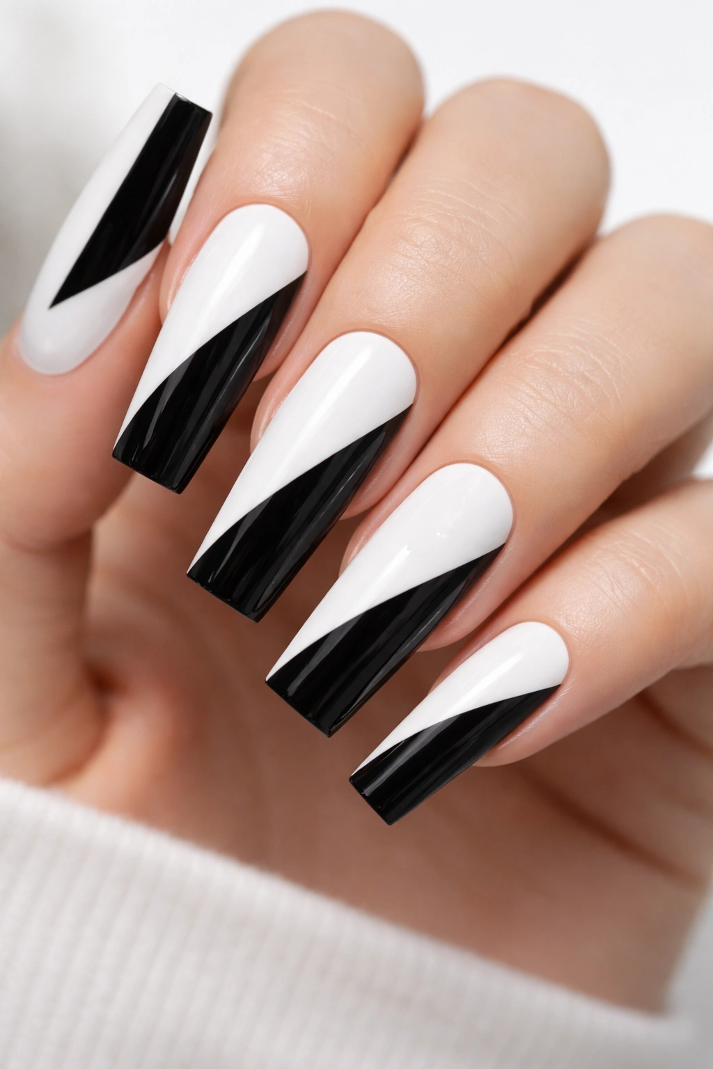 Close-up of coffin nails with an oversized black triangle on white base.