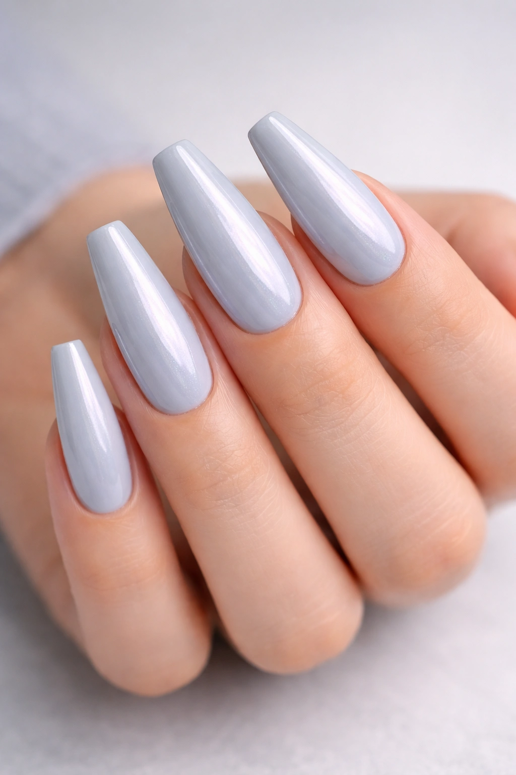 Close-up of pale blue-gray coffin nails showing subtle color shift