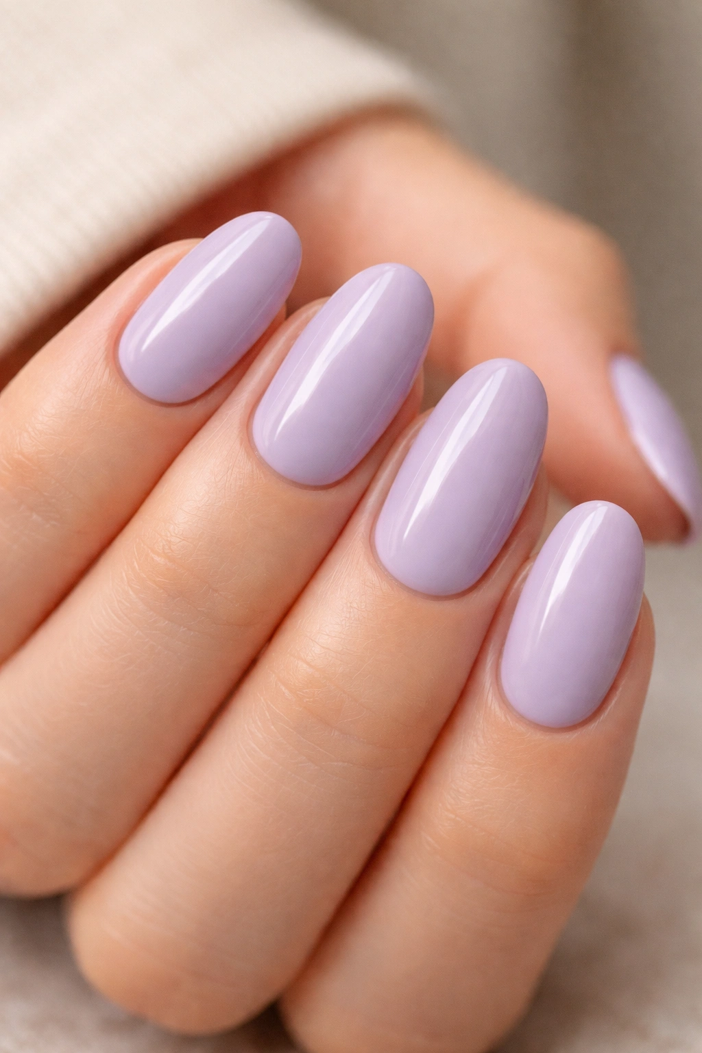 Close-up of pale lavender short oval gel nails with glossy finish