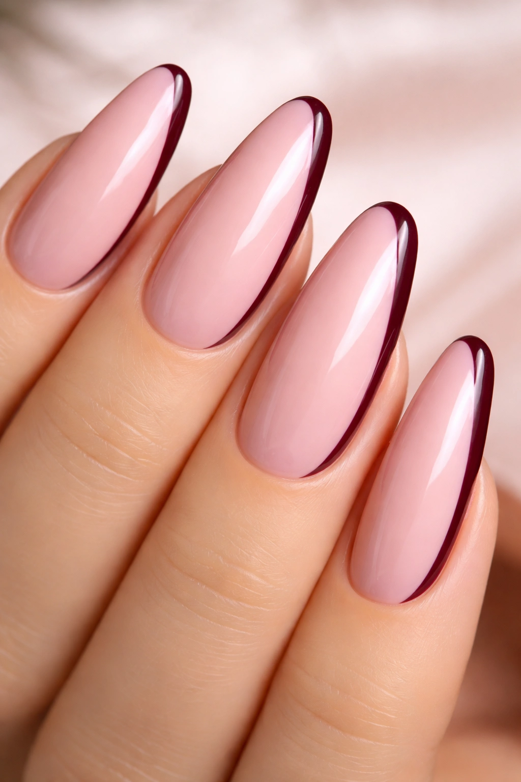 Pale pink nail with burgundy side line on the outer edge