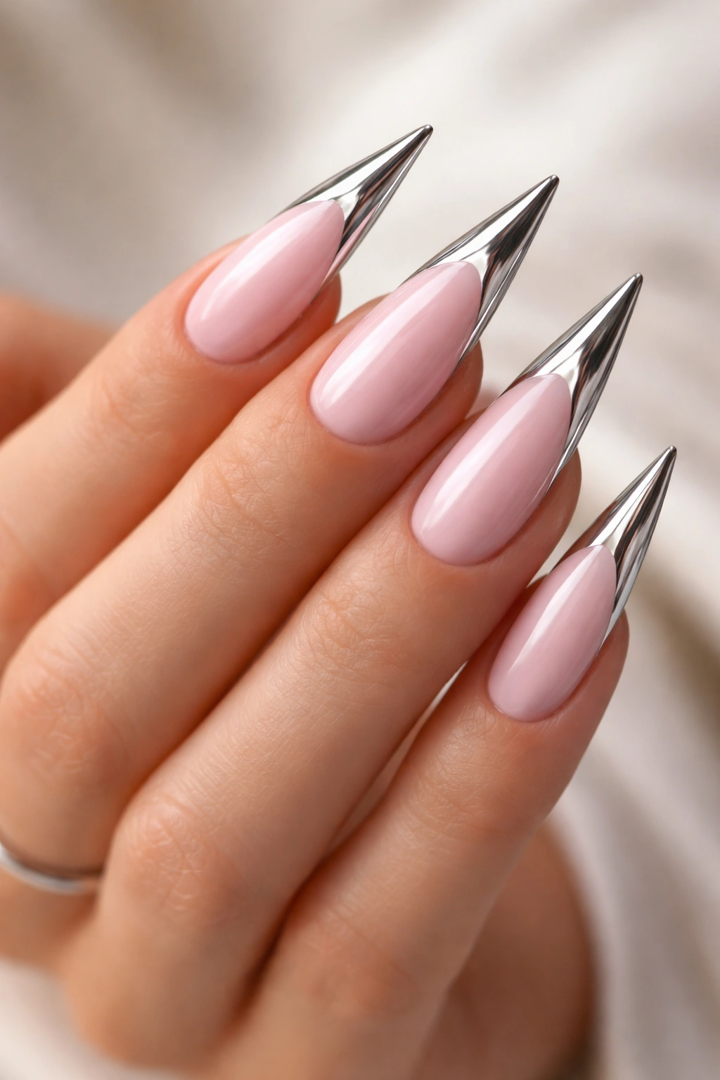 Pale pink stiletto nails with chrome tips