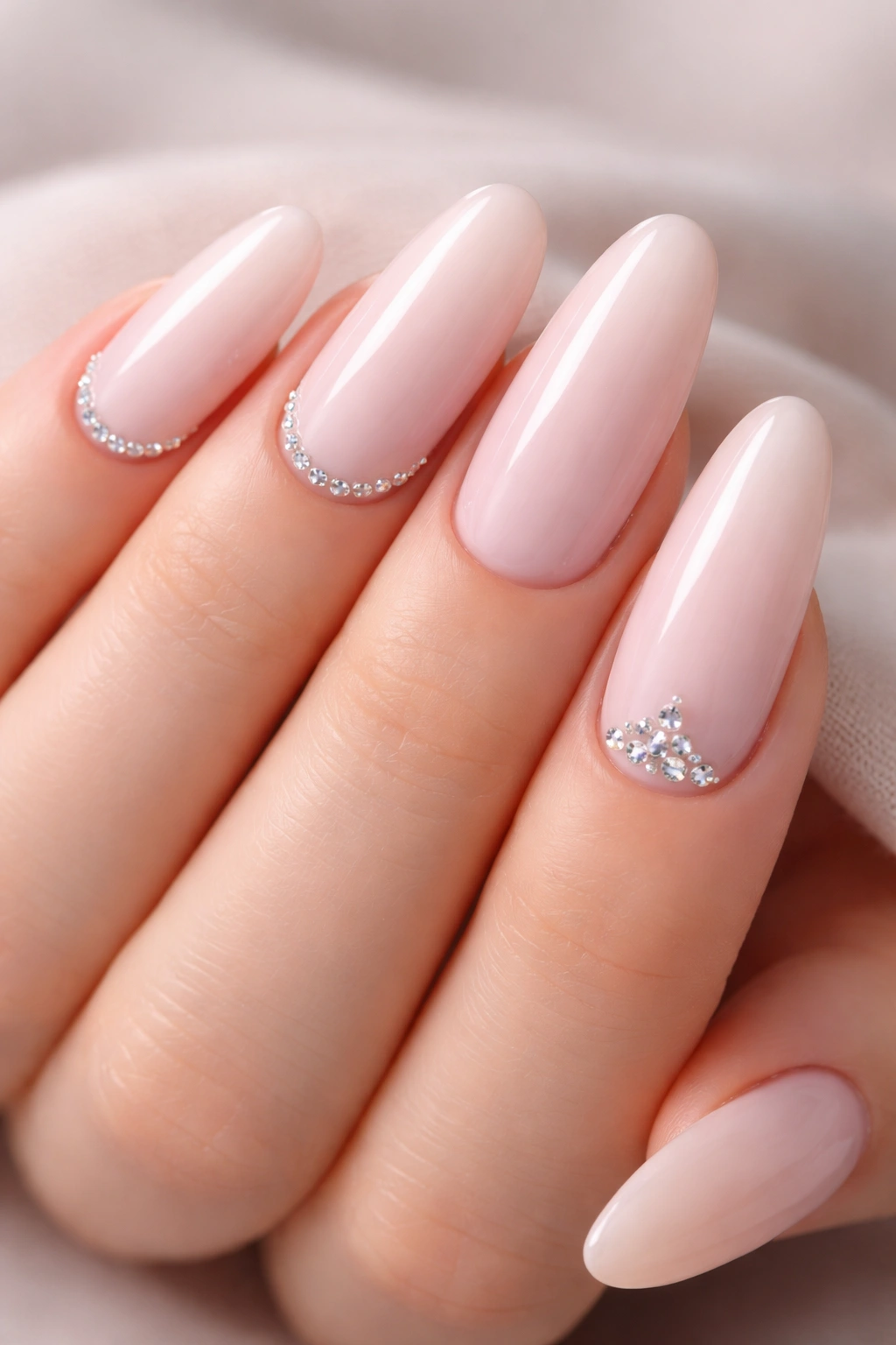 Pale pink oval nails with tiny diamond studs