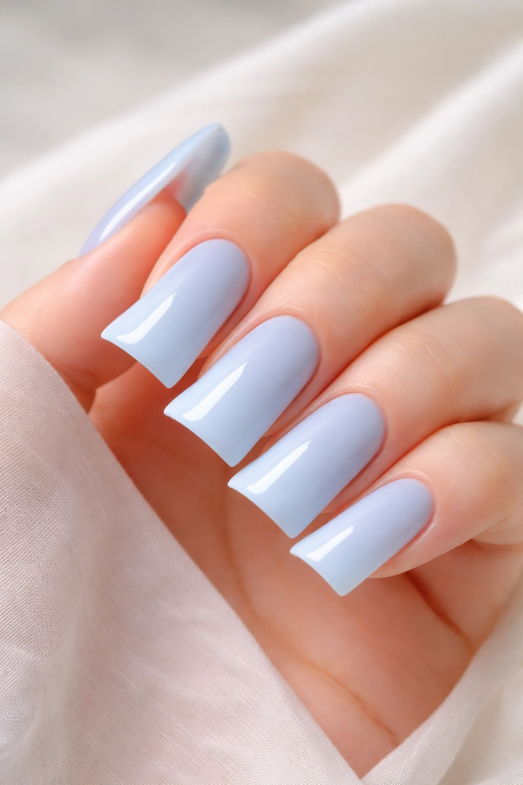 Pastel blue duck nails with milky finish.