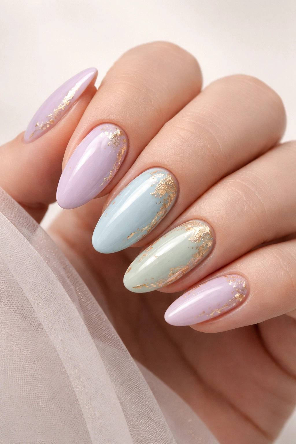 Pastel nails with gold foil accents and glossy finish