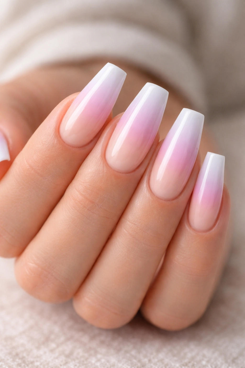 Close-up of coffin nails with pastel ombré from lavender to pink to white