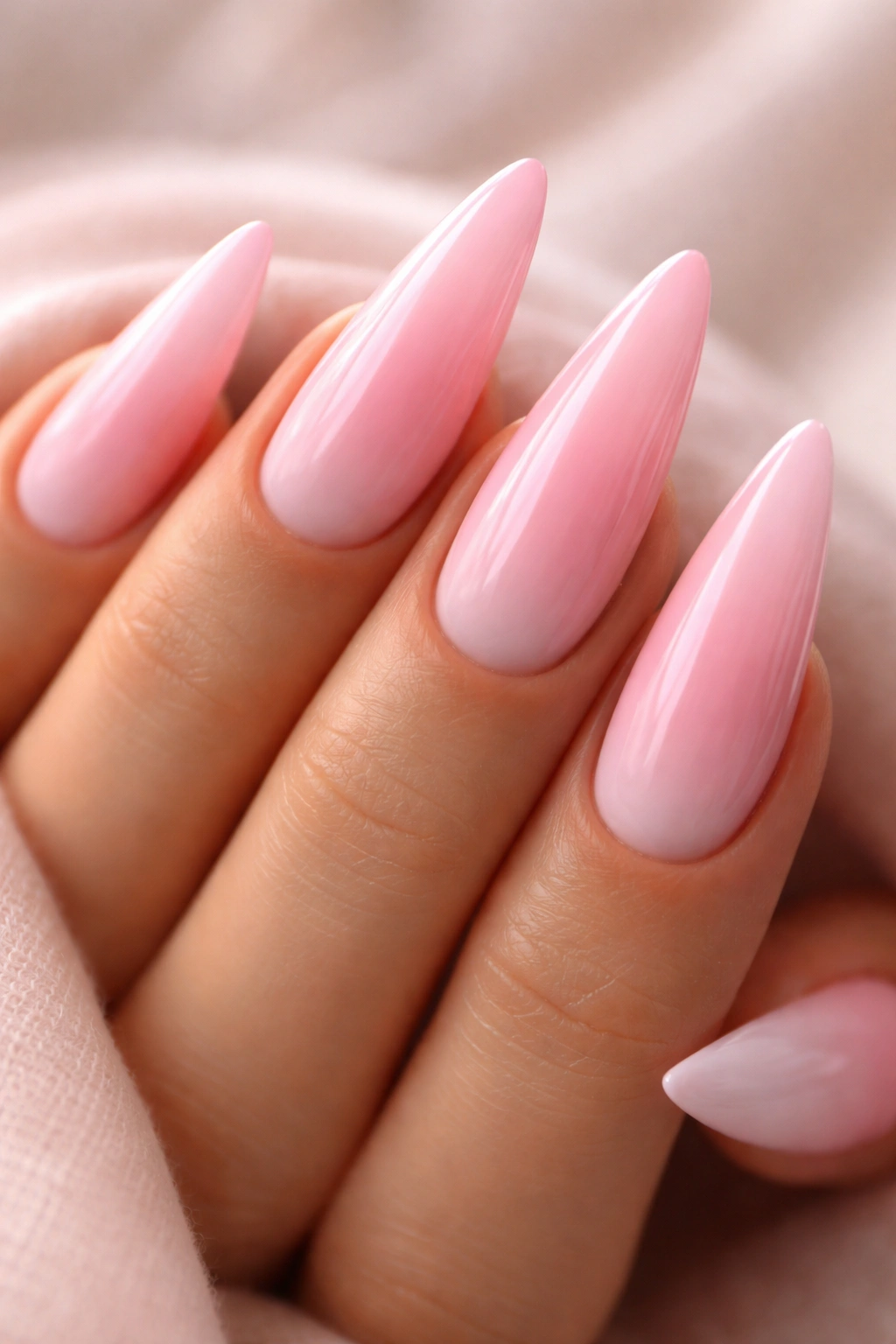 Pastel pink ombre stiletto nail with gradient from pale to deep pink