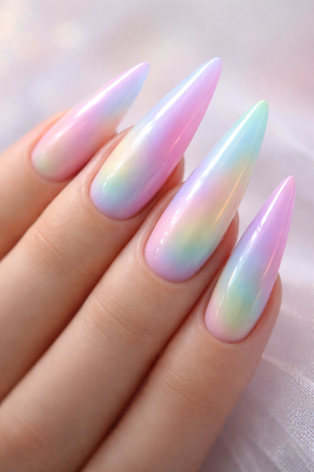 Pastel rainbow aura nails on stiletto shape with soft gradient