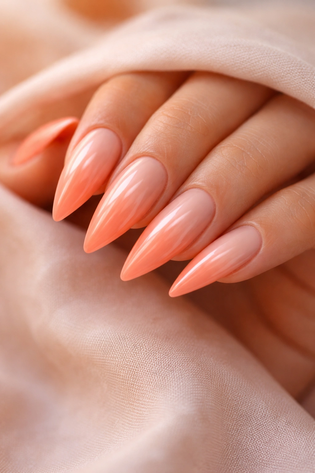 Peach gradient nails on medium stiletto nails with sunset-like fade