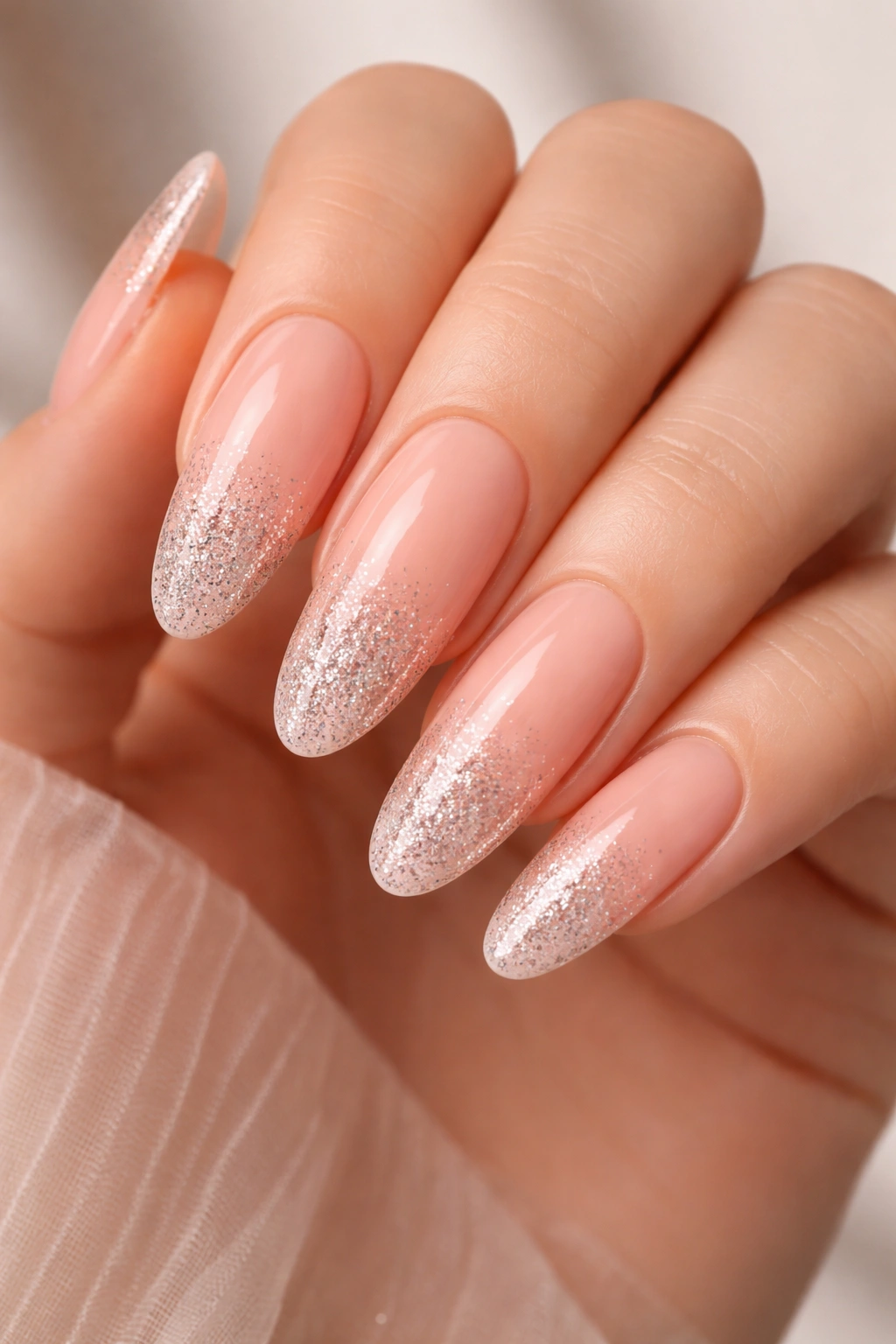 Soft peach nails with glitter ombre on long ovals