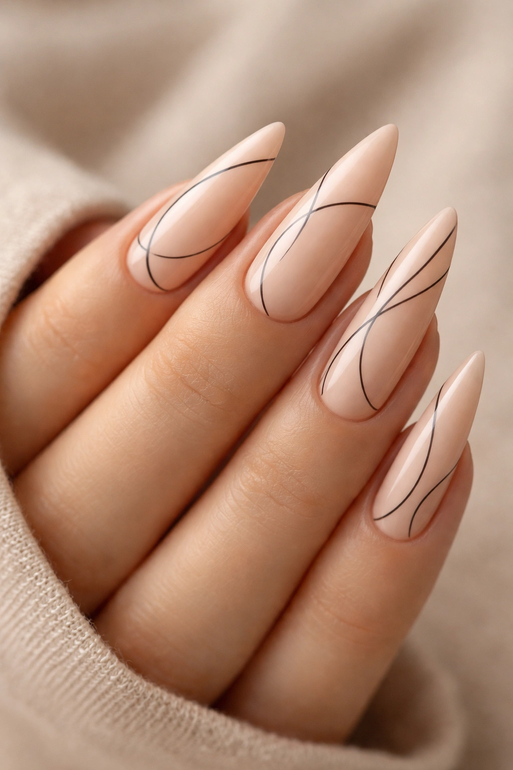 Pale peach stiletto nails with minimalist black line art