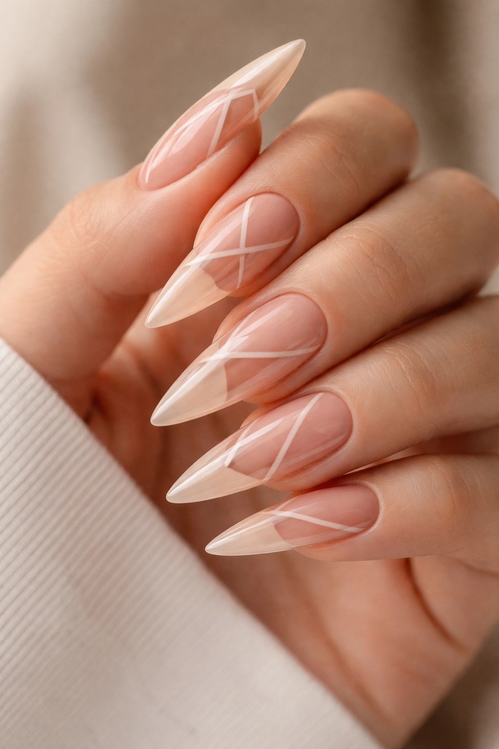 Peachy nude stiletto nails with negative space design