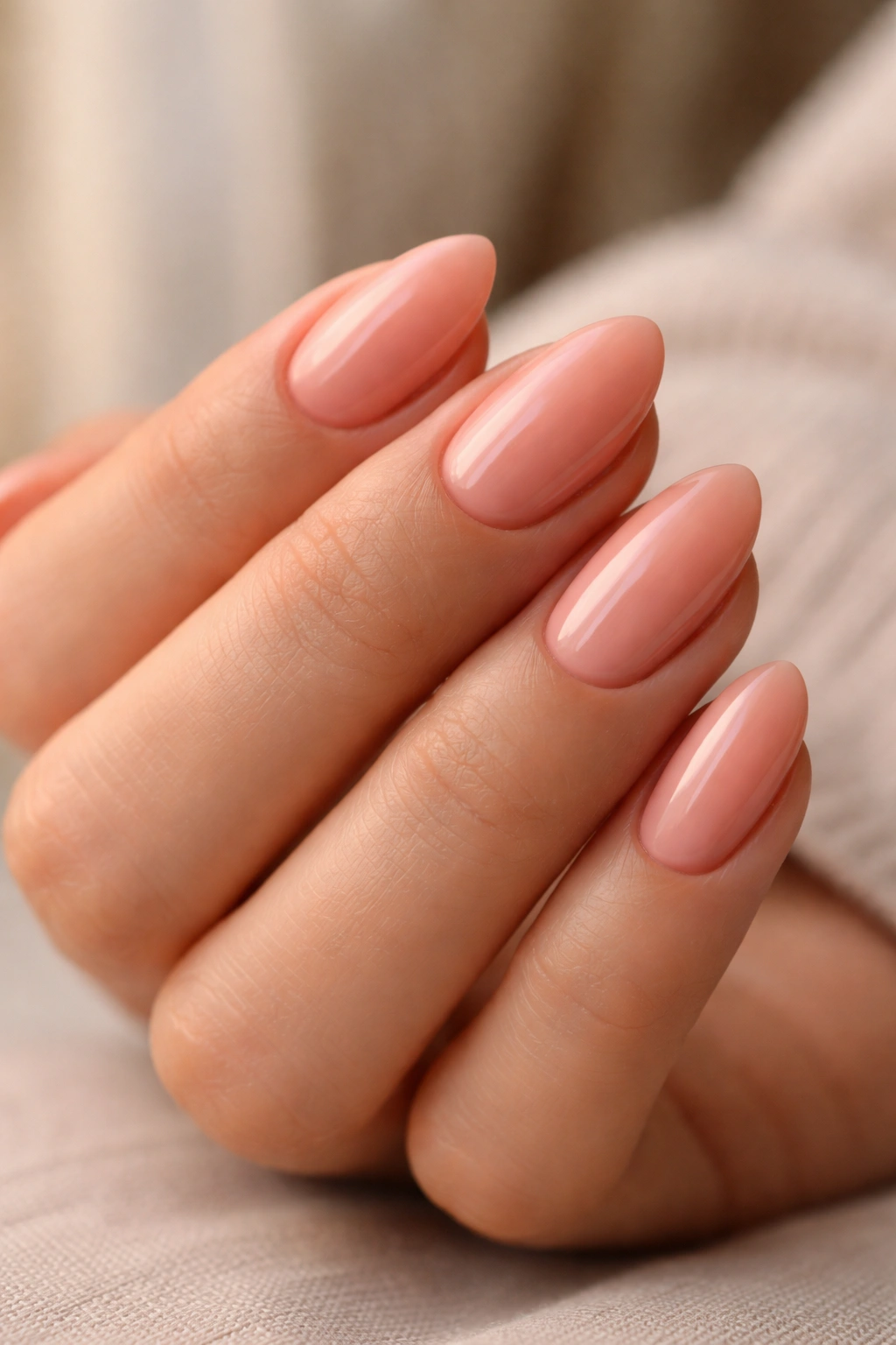 Peachy pink almond nails with warm undertone on short nails