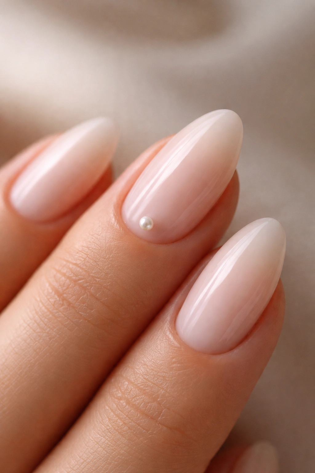 Macro shot of a tiny pearl accent on an almond nail