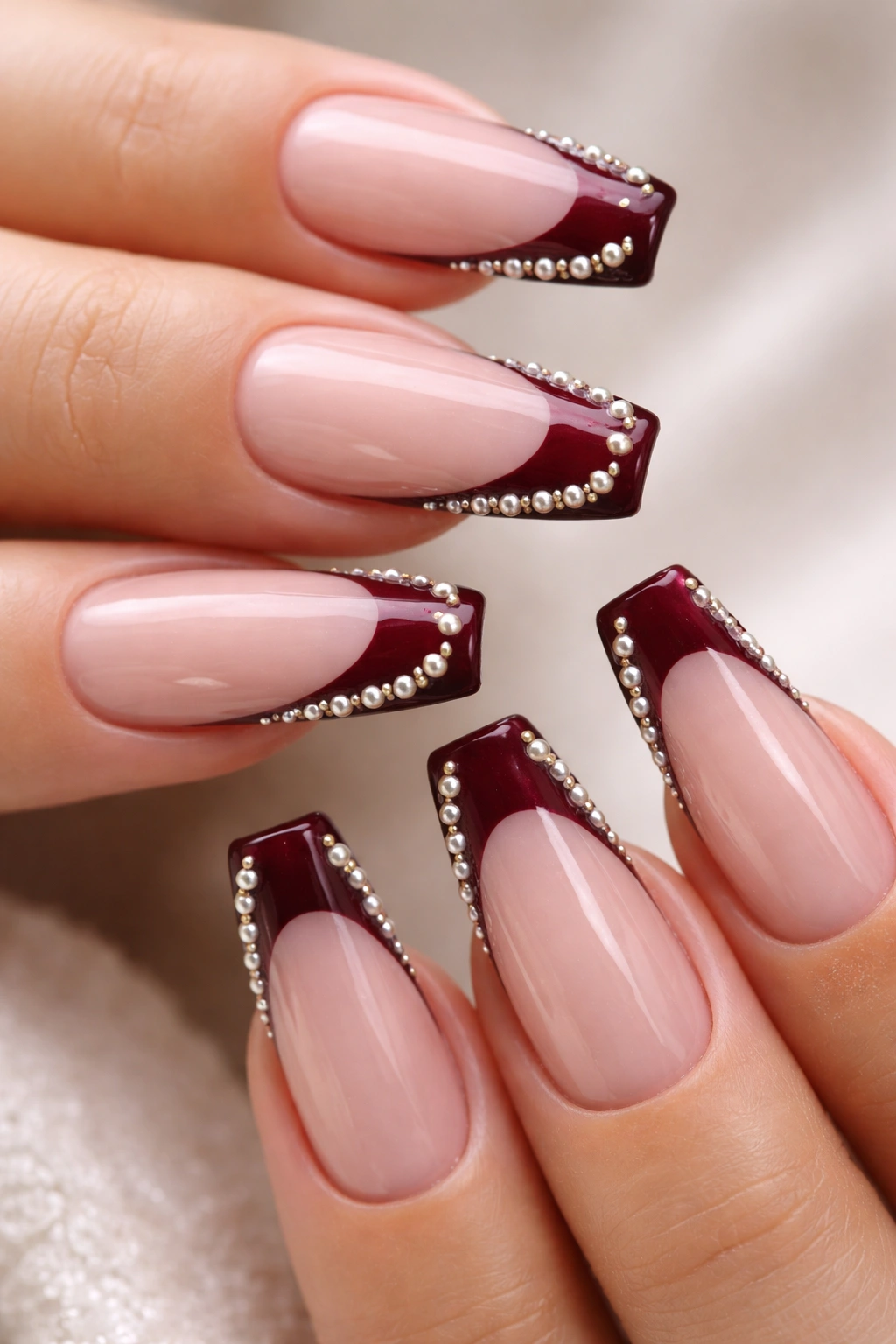 Burgundy coffin nails with tiny pearls along the tip