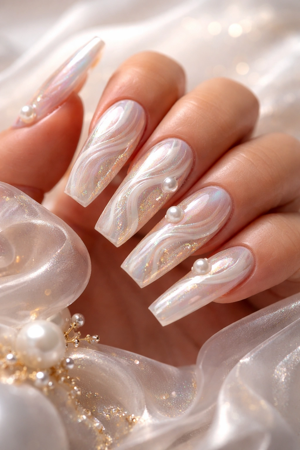 Nails with swirled pearl patterns and luminous iridescence