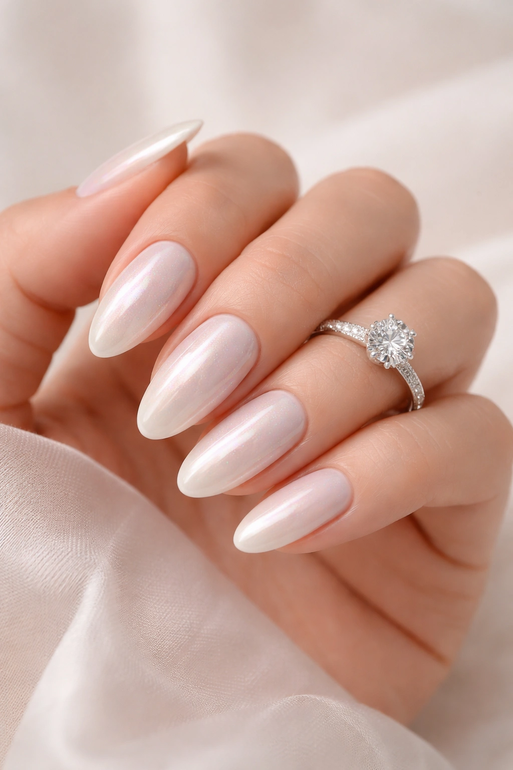 Close-up of pearl white nails with iridescent shimmer