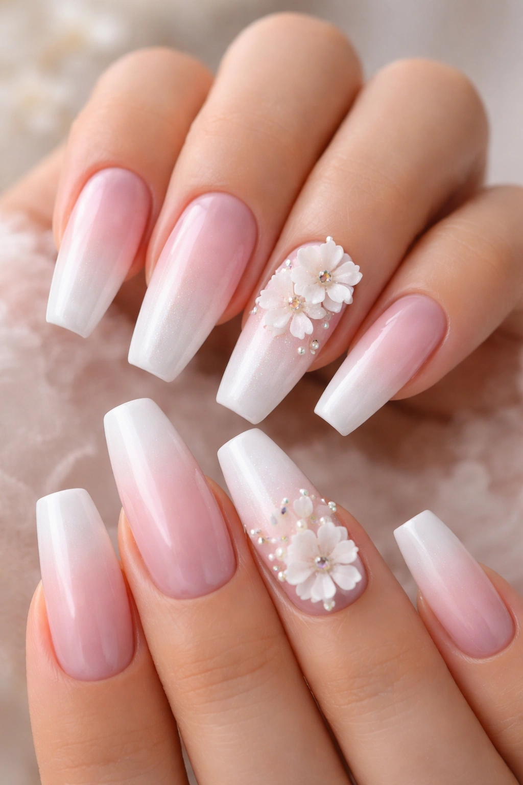Pearly pink and white nails with small 3D flowers on a ballerina shape