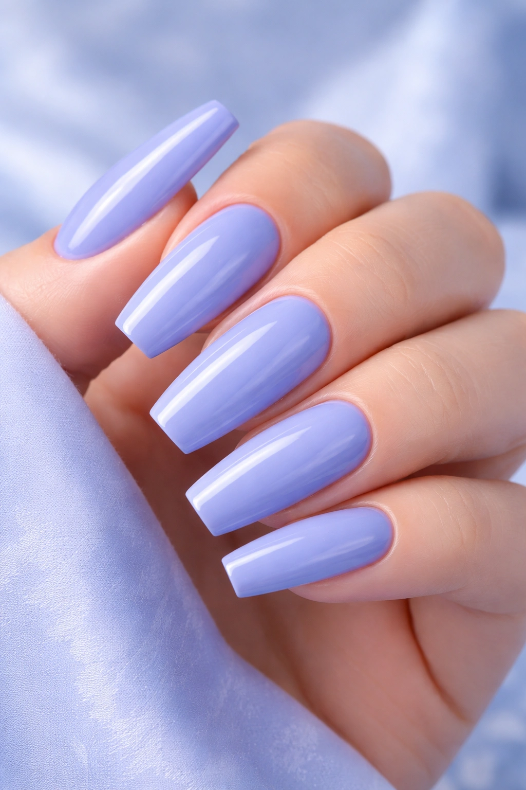 Close-up of periwinkle blue acrylic nails with lavender undertones