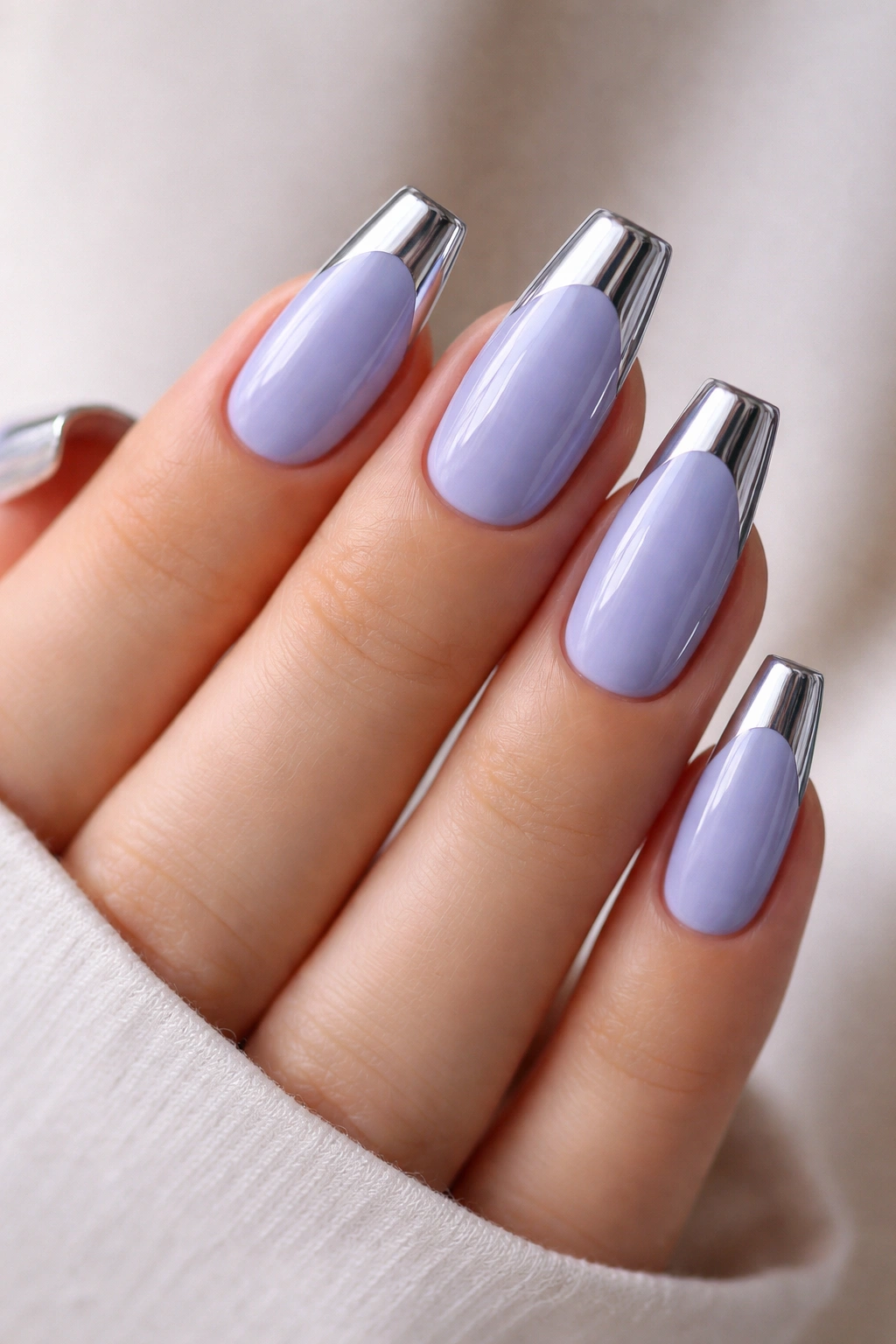 Close-up of periwinkle nails with chrome accent on coffin nails