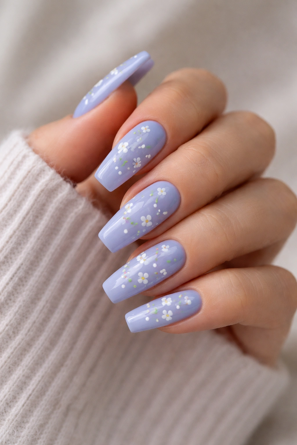 Periwinkle nails with white floral designs close-up