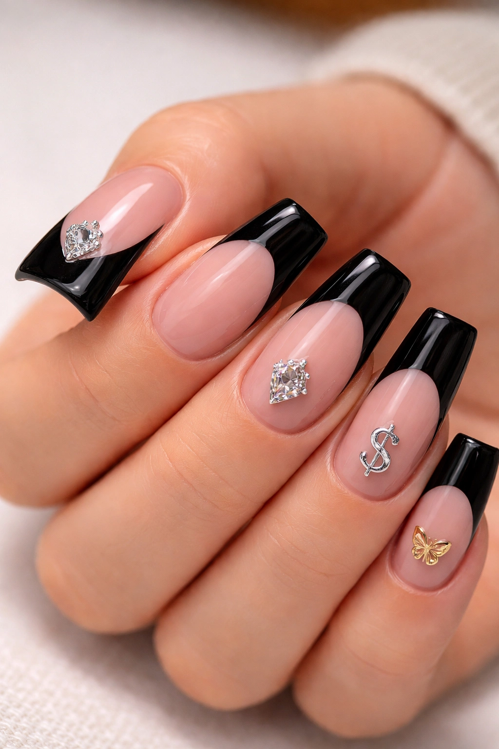 Close-up of duck-shaped nails with tiny personalized symbols near the black tip